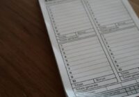 white paper document on brown wooden table